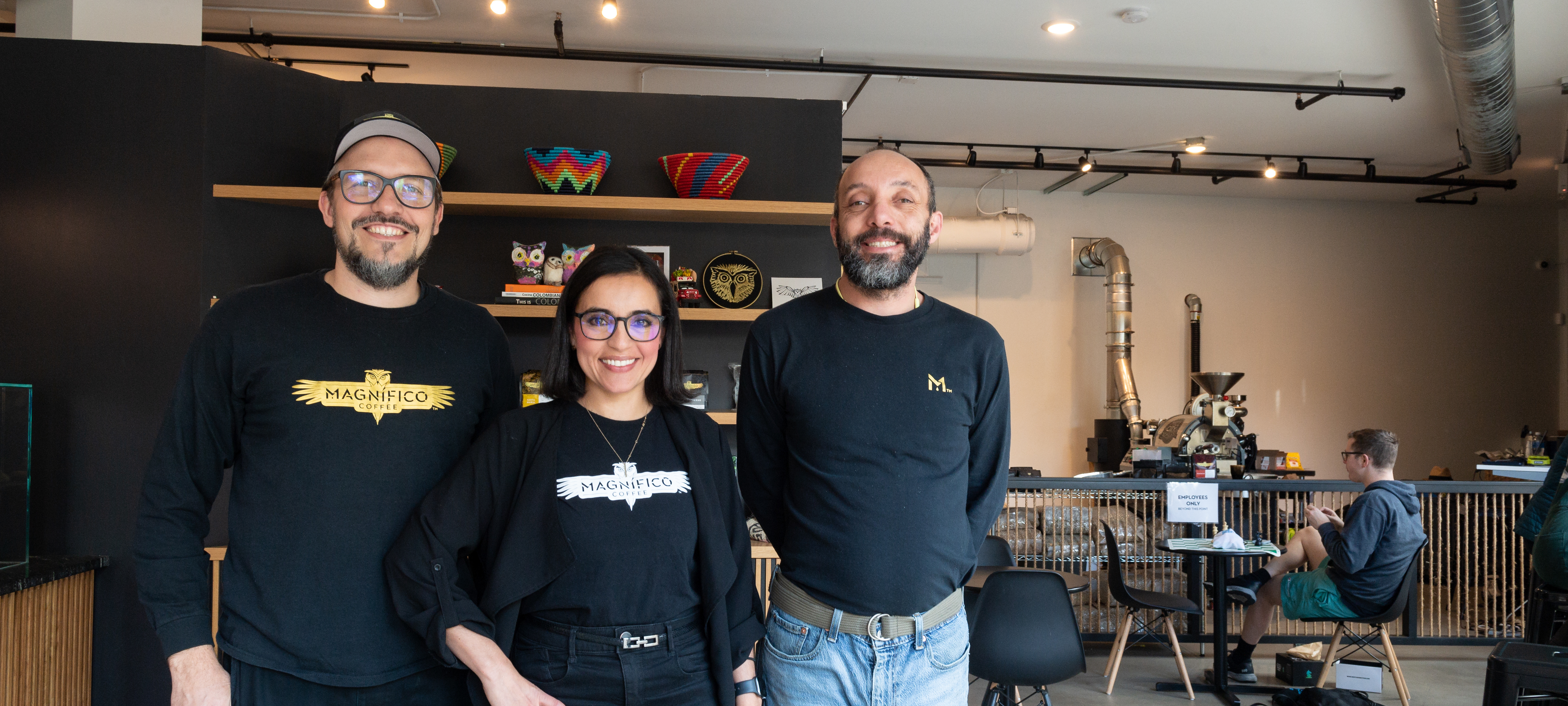 Owners pose inside of Magnifico Coffee Roasters